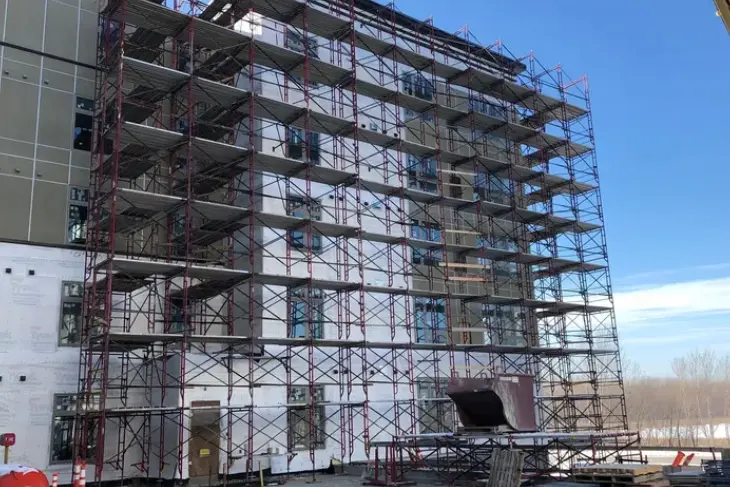 A building with scaffolding around it and some windows.